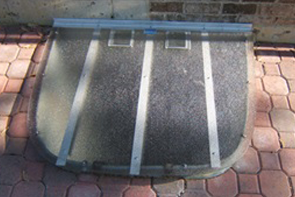 Clear G.E. Lexan window well cover custom fitted to galvanized well